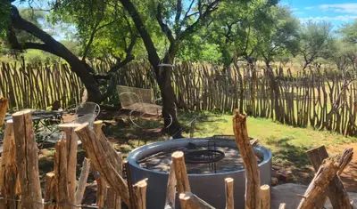 a hot tub in a garden with a fence at Ada Selah in Bela-Bela