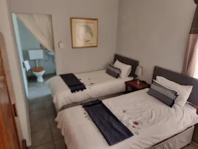 a room with three beds in a room at Ada Selah in Bela-Bela