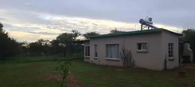 a small white house with a turbine on top of it at Ada Selah in Bela-Bela