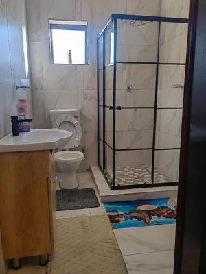 a bathroom with a shower with a toilet and a sink at Choosers Express Boutique Hotel Room 3 in Centurion