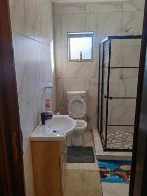 a small bathroom with a toilet and a sink at Choosers Express Boutique Hotel Room 3 in Centurion