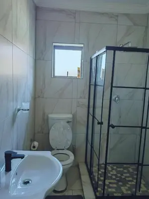 a bathroom with a toilet and a shower and a sink at Choosers Express Boutique Hotel Room 3 in Centurion