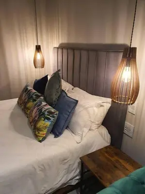 a bedroom with a bed with pillows and a table at Silver Views Guest Suite - No loadshedding! in Pretoria