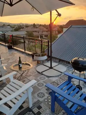 a patio with two chairs and a table and an umbrella at Silver Views Guest Suite - No loadshedding! in Pretoria