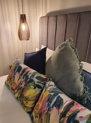 a bed with pillows and a headboard with at Silver Views Guest Suite - No loadshedding! in Pretoria