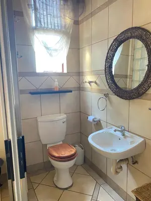 a bathroom with a toilet and a sink at Texas Phalaborwa guesthouse in Phalaborwa