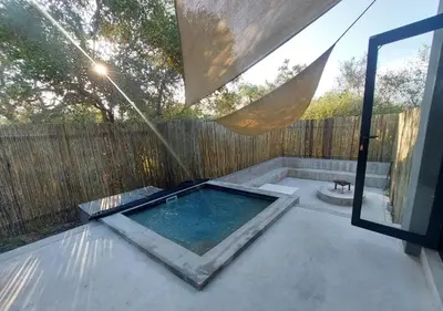 a hot tub on a patio next to a fence at House Motswiri in Marloth Park