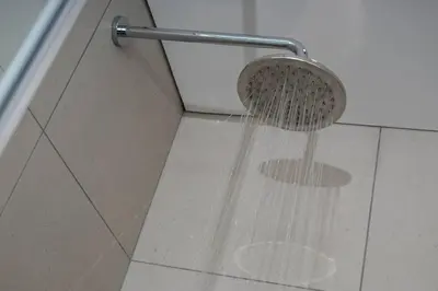a shower with water pouring from a shower head at Modern Luxury Apartment, Ellipse in Midrand