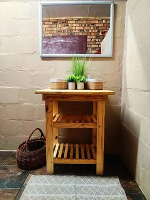 a wooden table with plants on it next to a wall at 2K City Studios Not Self catering in Graskop
