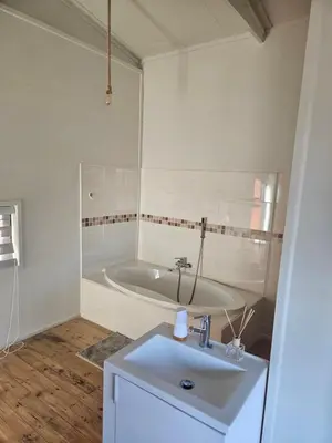 a white bathroom with a sink and a tub at Emintha Log House in Mmukubyane
