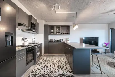 a kitchen with a sink and a counter top at Stylish Stunner in Circa 205 in Pretoria