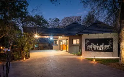 a house with a driveway at night with lights at Idube Game Reserve in Sabi Sand Game Reserve