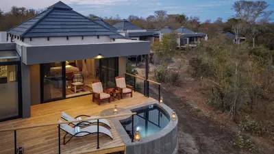 a house with a deck and a swimming pool at Idube Game Reserve in Sabi Sand Game Reserve
