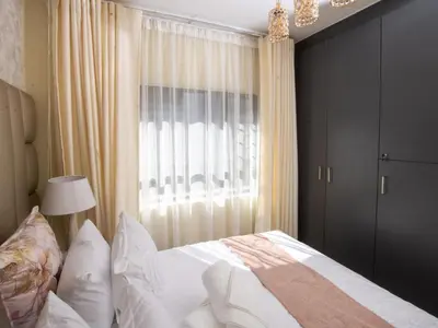 a bedroom with a white bed and a window at Elegance At Waterfall Ridge in Midrand