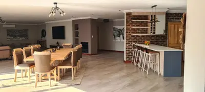 a dining room and kitchen with a table and chairs at Ikigai4617 Villa in Marloth Park