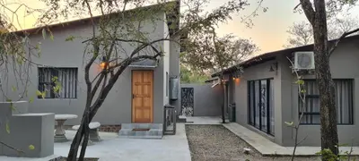 a house with a wooden door in a yard at Ikigai4617 Villa in Marloth Park