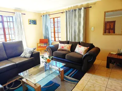 a living room with a couch and a coffee table at Ikhayalethu in Centurion
