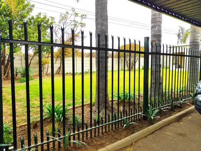 a black fence in front of a yard at Ikhayalethu in Centurion