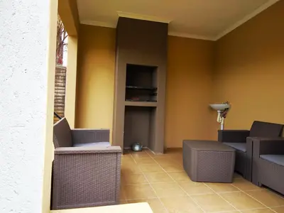 a living room with two chairs and a tv at Ikhayalethu in Centurion