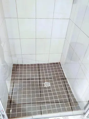 a shower with a tiled floor in a bathroom at Ikhayalethu in Centurion