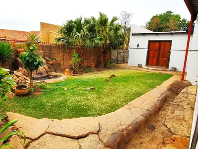 a backyard with a lawn with a hose at Ikhayalethu in Centurion