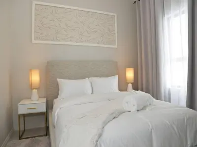 a white stuffed animal sitting on top of a bed at Elcaro Luxury Villas - Urban Taupe 1 in Midrand