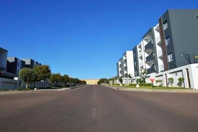 an empty street in front of a building at Elcaro Luxury Villas - Urban Taupe 1 in Midrand