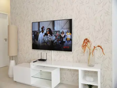 a living room with a tv on a wall at Elcaro Luxury Villas - Urban Taupe 1 in Midrand