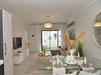 a living room with a couch and a table at Elcaro Luxury Villas - Urban Taupe 1 in Midrand