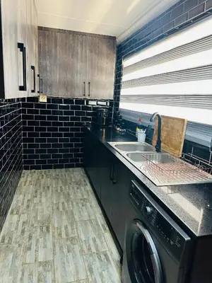 a kitchen with a washing machine and a sink at Jobak Farm House in Bela-Bela