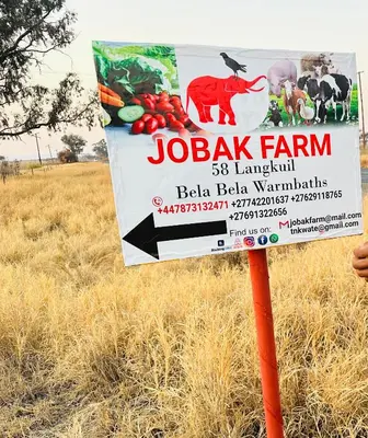a sign for a jaji farm in a field at Jobak Farm House in Bela-Bela