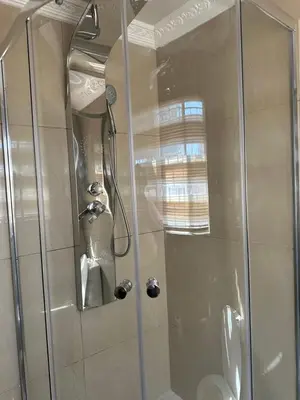 a shower with a glass door in a bathroom at Jobak Farm House in Bela-Bela