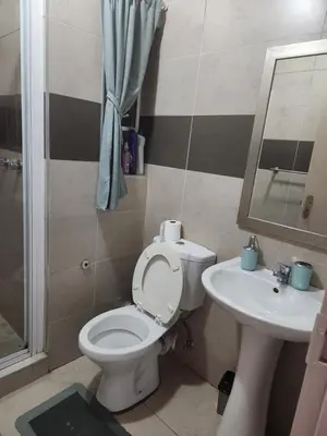 a bathroom with a toilet and a sink at Menlyn Place City Vibes in Pretoria