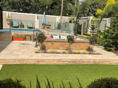 a garden with a couch in the middle of a lawn at TG Villa Menlyn in Pretoria