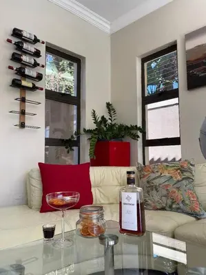 a living room with a bottle of wine on a table at TG Villa Menlyn in Pretoria