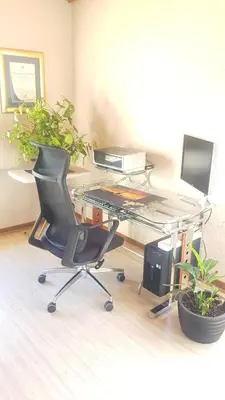 an office with a desk with a keyboard and a chair at Dali in Pretoria