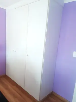 a white closet with white walls and wooden floors at Dali in Pretoria