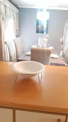 a table with a white plate on top of it at Dali in Pretoria