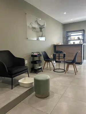 a living room with chairs and a table at Kruger Living on Nyati in Malelane
