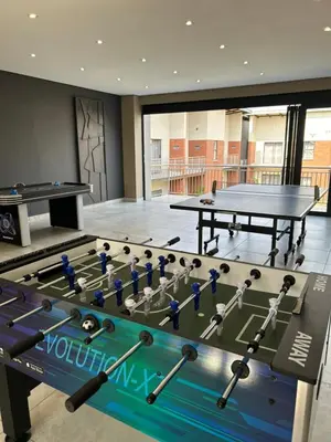 a gym with a pool table and a ping pong table at Kruger Living on Nyati in Malelane