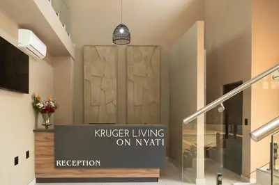 a lobby with a sliding door in a building at Kruger Living on Nyati in Malelane