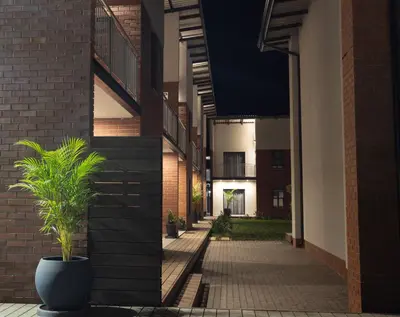 a hallway of a building with a potted plant at Kruger Living on Nyati in Malelane