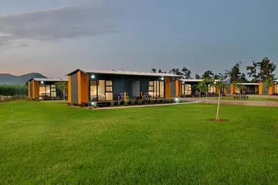 a row of houses in a field of grass at SleepOver Malelane in Malelane