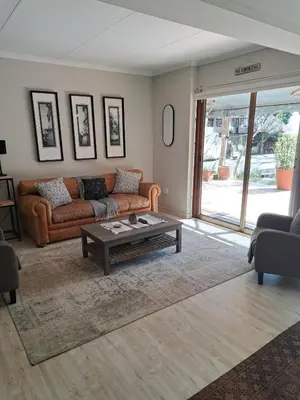 a living room with a couch and a coffee table at 258 on Aries in Pretoria
