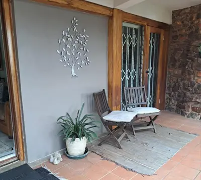 a porch with a bench and a potted plant at 258 on Aries in Pretoria