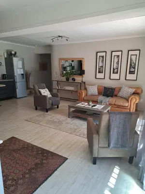 a living room with couches and a coffee table at 258 on Aries in Pretoria