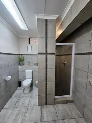 a bathroom with a toilet and a shower in it at 258 on Aries in Pretoria