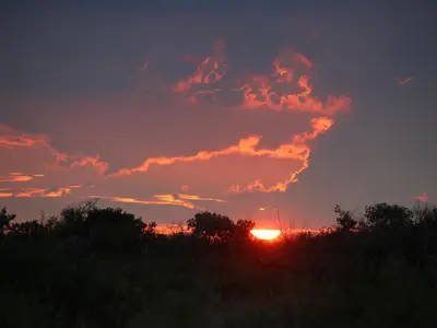 a sunset with the sun setting in the sky at Fairview Manor in Modimolle