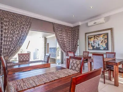 a dining room with a table and chairs at Fairview Manor in Modimolle