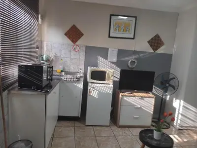 a kitchen with a refrigerator and a microwave at Blessing secure unit in Pretoria